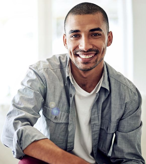 man smiling while relaxing at home